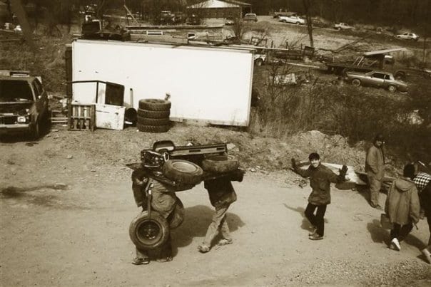 people carrying car parts